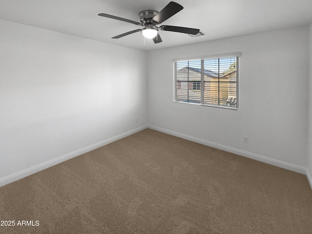 spare room with ceiling fan and carpet