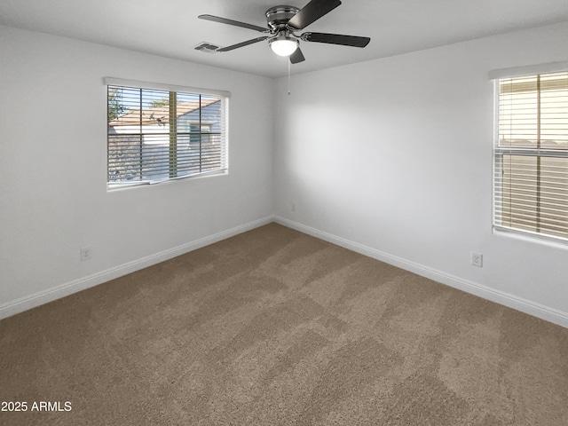 empty room featuring ceiling fan and carpet flooring