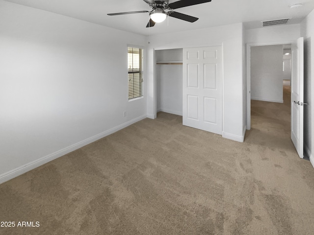 unfurnished bedroom with a closet, ceiling fan, and light colored carpet