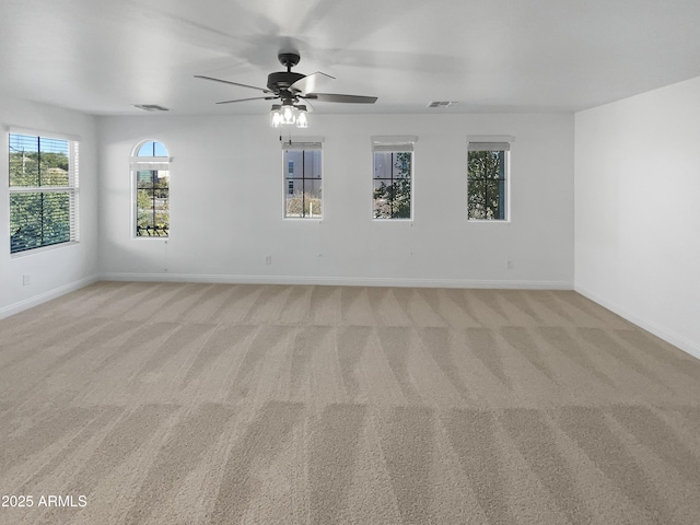 spare room with light colored carpet and ceiling fan