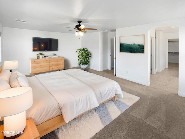 bedroom featuring ceiling fan and light carpet