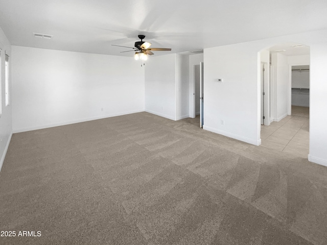 carpeted spare room with ceiling fan