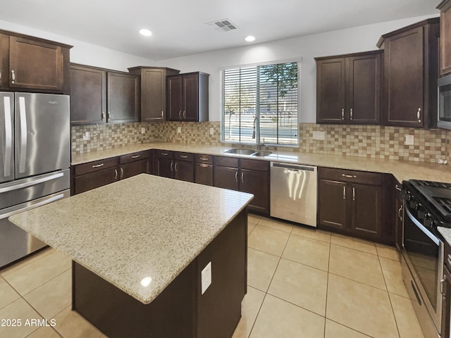 kitchen with backsplash, stainless steel appliances, a center island, sink, and light tile patterned flooring