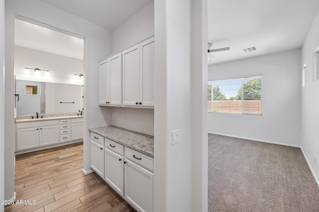 898 E Ladbroke Way, Gilbert, AZ 85297 - corridor with a sink, baseboards, and light wood-style floors