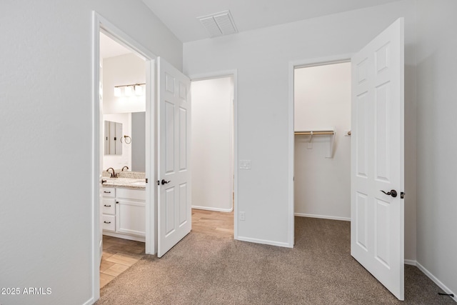 898 E Ladbroke Way, Gilbert, AZ 85297 - unfurnished bedroom featuring a spacious closet, a closet, light carpet, and ensuite bathroom