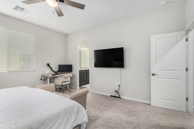 bedroom with connected bathroom, light colored carpet, and ceiling fan