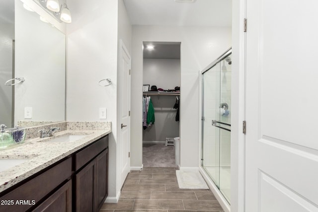 bathroom featuring an enclosed shower and vanity