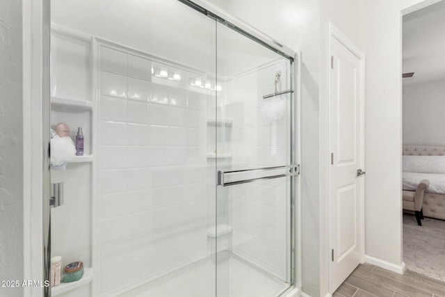 bathroom featuring a shower with shower door