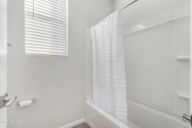 bathroom featuring shower / tub combo with curtain