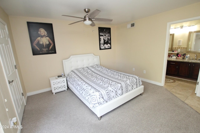 9450 N 95th St Unit 219, Scottsdale, AZ 85258 - bedroom with light colored carpet, a sink, baseboards, connected bathroom, and ceiling fan