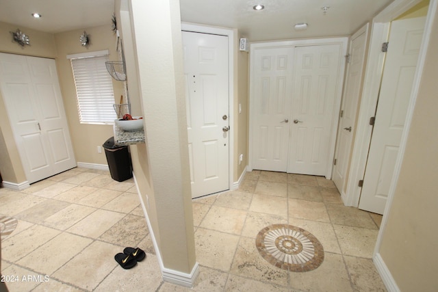9450 N 95th St Unit 219, Scottsdale, AZ 85258 - corridor with baseboards, stone tile floors, and recessed lighting
