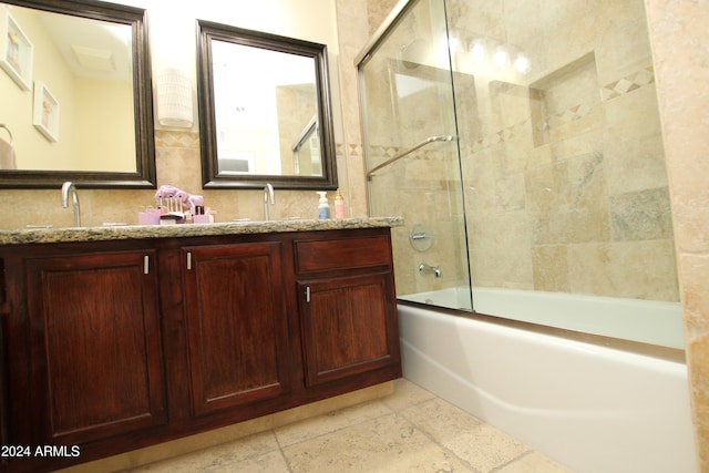 bathroom featuring vanity, enclosed tub / shower combo, and tile patterned flooring