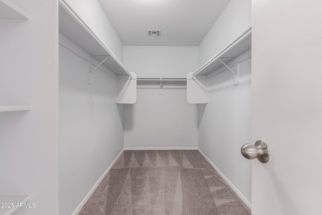 walk in closet featuring carpet flooring and visible vents