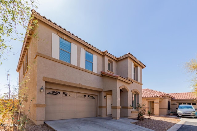 view of front of house featuring stucco siding, concrete driveway, an attached garage, and a tiled roof