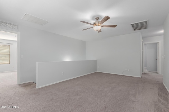 carpeted empty room featuring visible vents, baseboards, and ceiling fan