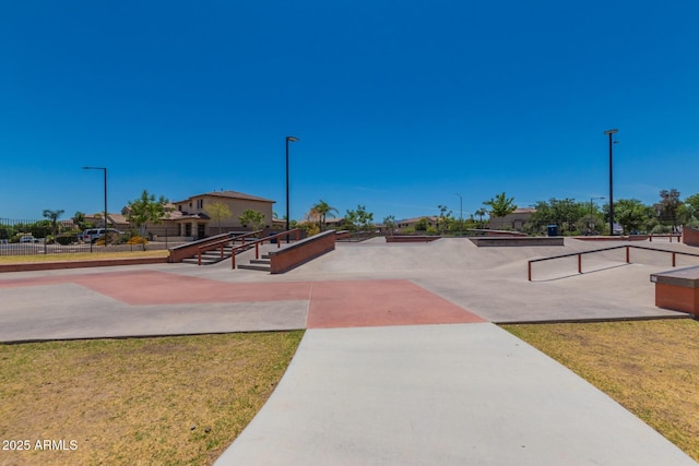 view of property's community featuring a lawn and fence