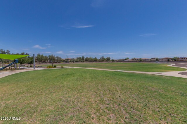 view of property's community with a lawn and playground community