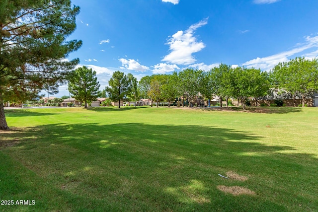 surrounding community featuring playground community and a yard