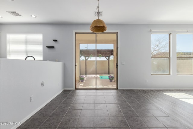 unfurnished dining area with dark tile patterned floors, visible vents, recessed lighting, and baseboards