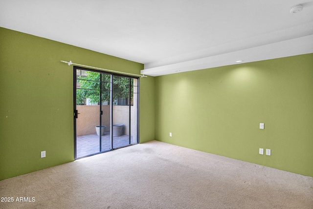 empty room featuring carpet floors and a smoke detector