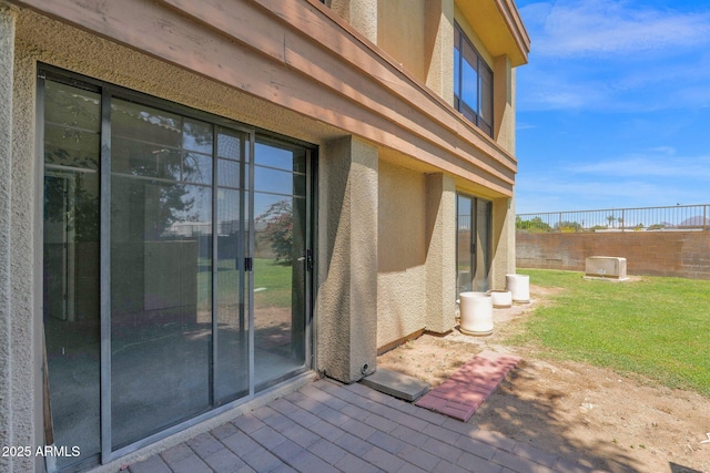 entrance to property featuring stucco siding