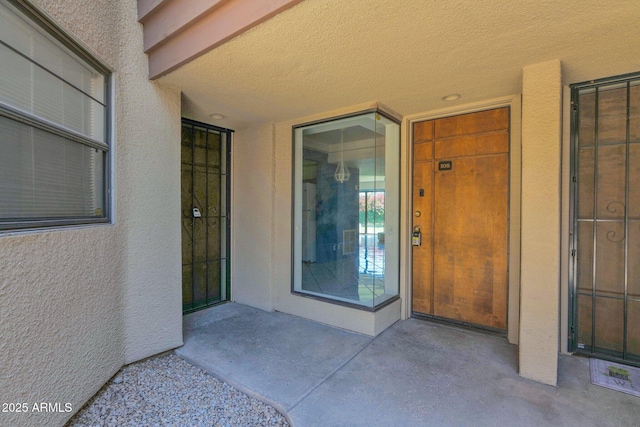 view of exterior entry with stucco siding