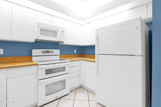 kitchen featuring white appliances, butcher block counters, white cabinets, and light tile patterned floors