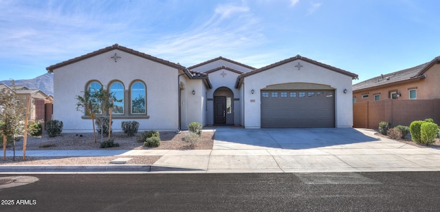 mediterranean / spanish-style home with a garage