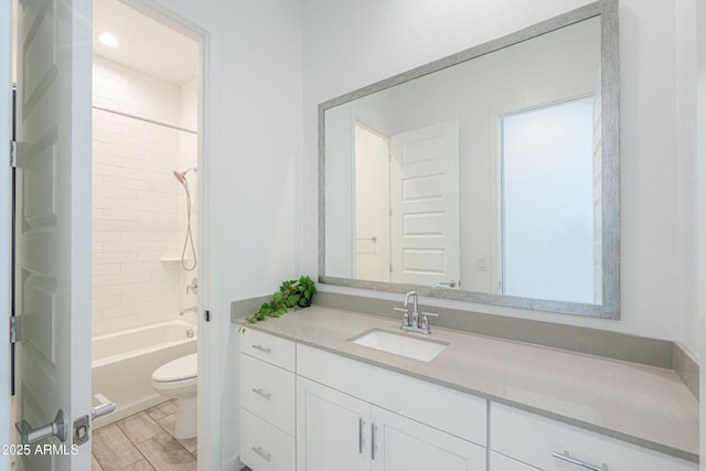 full bathroom featuring vanity, toilet, and tiled shower / bath