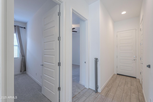 hallway with light colored carpet