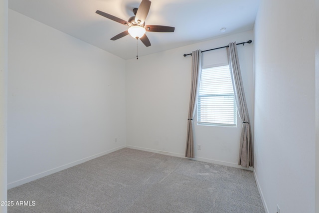 unfurnished room with ceiling fan and light colored carpet