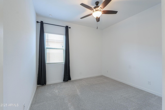 unfurnished room with ceiling fan and light carpet