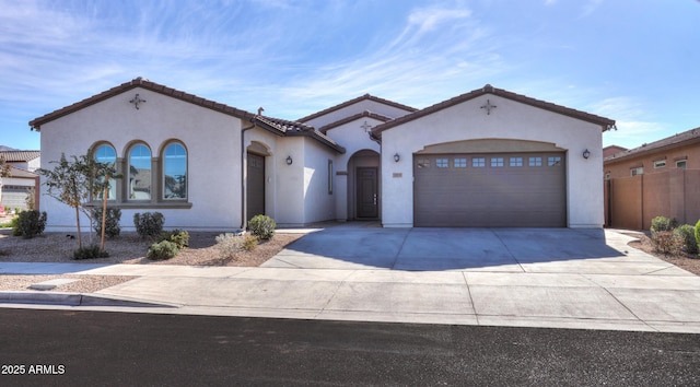 mediterranean / spanish-style home with a garage