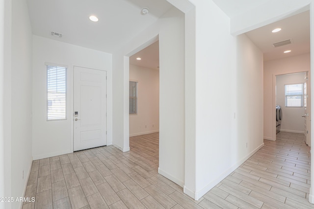 foyer entrance with separate washer and dryer