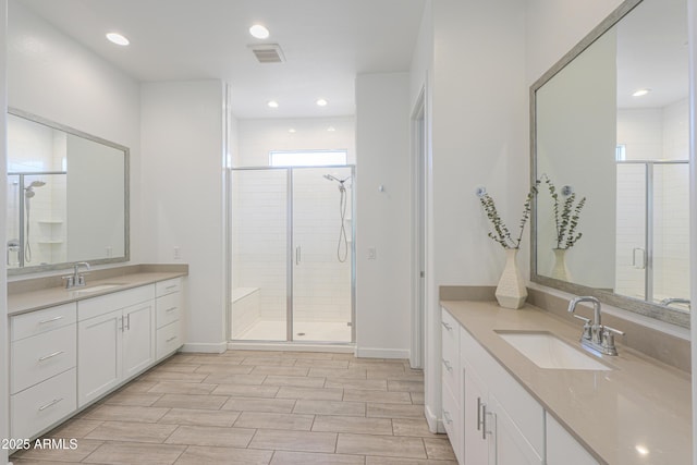 bathroom featuring vanity and a shower with door