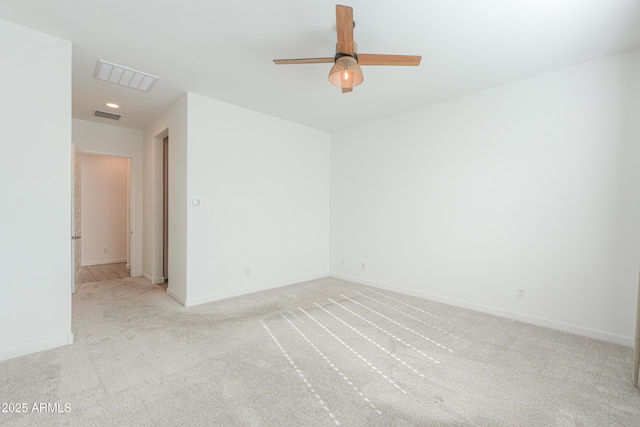 carpeted spare room featuring ceiling fan