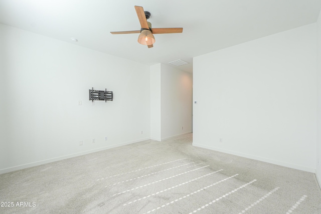 empty room featuring light carpet and ceiling fan