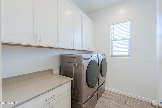 washroom featuring cabinets and washer and dryer