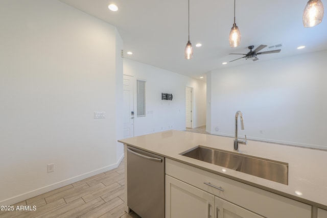 kitchen with dishwasher, pendant lighting, ceiling fan, and sink