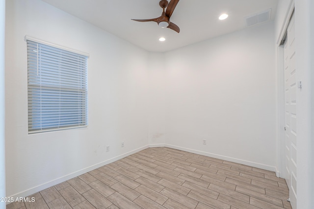 empty room featuring ceiling fan and light wood-type flooring