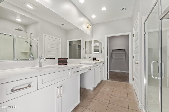 bathroom featuring vanity, a shower with shower door, and tile patterned floors