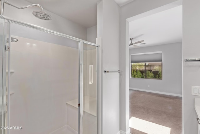 bathroom featuring ceiling fan and an enclosed shower