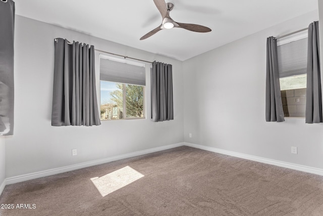 unfurnished room with ceiling fan and carpet flooring