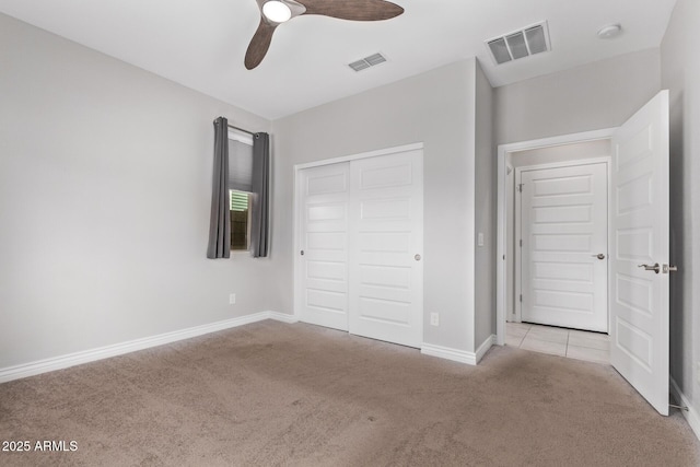 unfurnished bedroom with light carpet, a closet, and ceiling fan