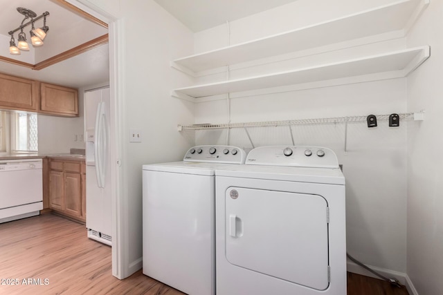 laundry room with light hardwood / wood-style floors and washing machine and clothes dryer