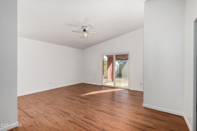 unfurnished room with hardwood / wood-style flooring, ceiling fan, and vaulted ceiling