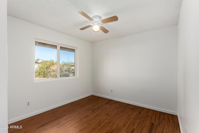 empty room with ceiling fan, hardwood / wood-style floors, and a textured ceiling