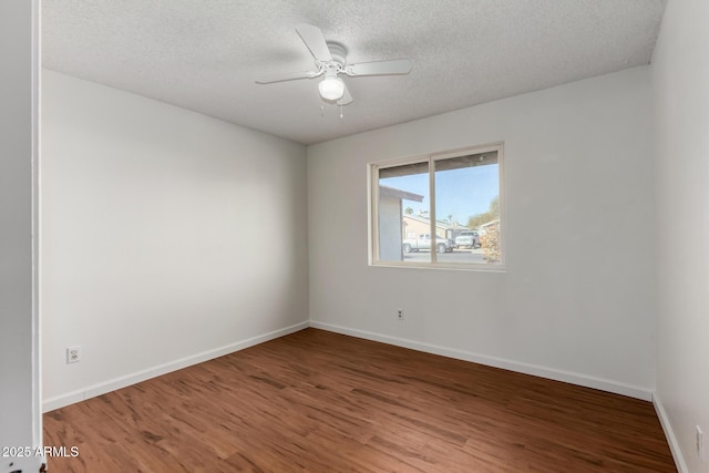 empty room featuring hardwood / wood-style flooring, a textured ceiling, and ceiling fan