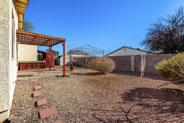 view of yard featuring a patio, a gazebo, a pergola, and a storage shed