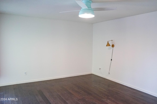 unfurnished room with dark hardwood / wood-style flooring